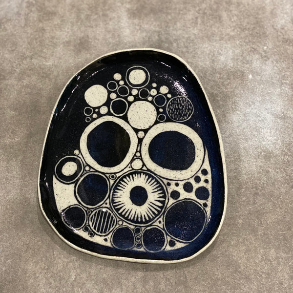 Decorative ceramic plate with abstract black and white Kiwi underglaze