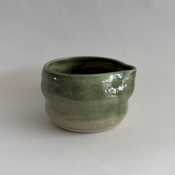 Green ceramic Matcha Tea bowl on a white background
