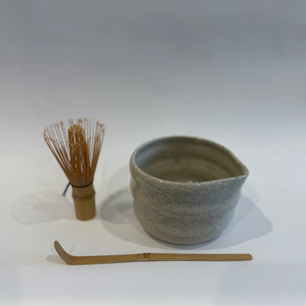 Matcha Tea-making set with a ceramic bowl, whisk and spoon on a white background